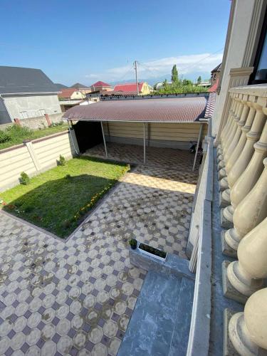 a view of a backyard with a building and a pool at Rauza Guest Villa in Bishkek