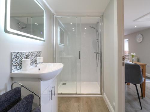 a bathroom with a shower and a sink at The Bottling Shed in Matlock