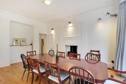 a dining room with a wooden table and chairs at Sanctuary Forest Row countryside village escape Pass the Keys in Forest Row