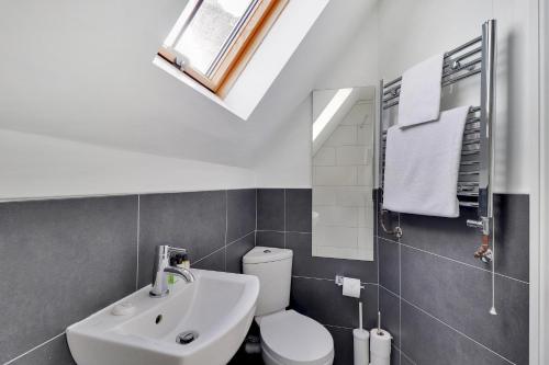 a bathroom with a white toilet and a sink at Sanctuary Forest Row countryside village escape Pass the Keys in Forest Row