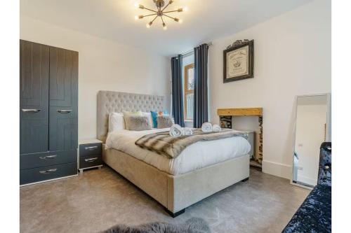 a bedroom with a large bed in a room at luxury Farmhouse: Hot Tub & Garden in Soutergate