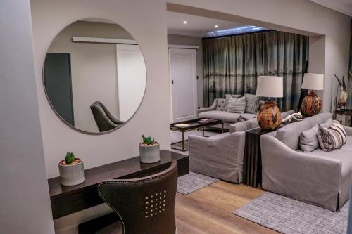 a living room with a large mirror on the wall at Cresta Mowana Safari Resort & Spa in Kasane