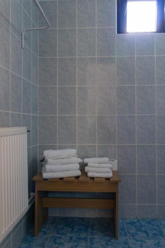a pile of towels sitting on a table in a bathroom at Vila Pufu in Slănic-Moldova