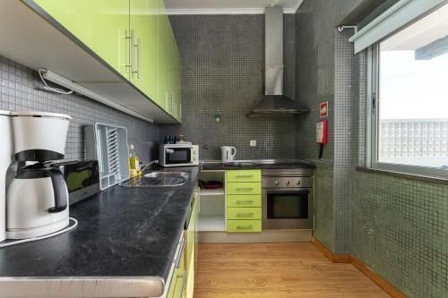 a kitchen with a counter with a coffee maker at Blife Bandaya private apartment in Faro