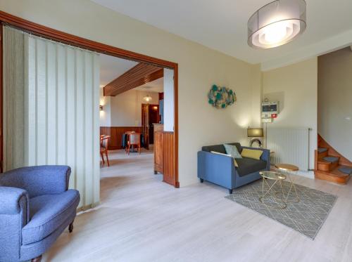 a living room with a blue couch and a table at Auberge d'ici et d'ailleurs in Cressensac