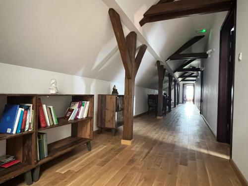 a hallway with wooden bookshelves and a hallway with books at Centrum Dialogu Kultur in Węgrów