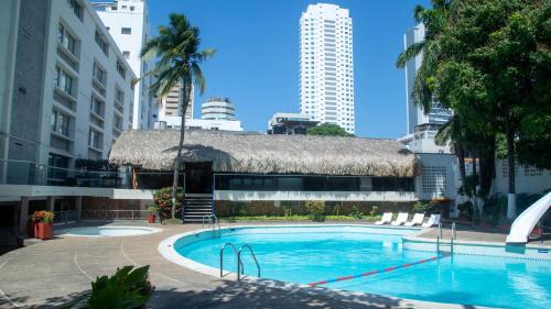 a large swimming pool in a city with buildings at Hotel Bahia Cartagena in Cartagena de Indias