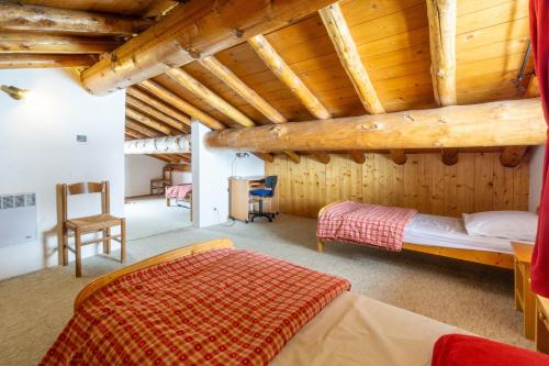 a bedroom with a bed in a room with wooden ceilings at Chalet Les moulins in Bonneval-sur-Arc