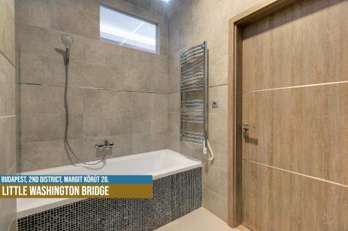 a bathroom with a shower and a bath tub at Little Americas Hillside Apartments in Budapest