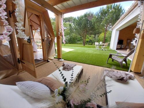 a room with a bed with flowers on it at Le Clos FMR Insolite - "F"anny Carcassonne in Malves-en-Minervois