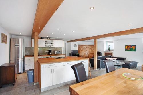 a kitchen and living room with a table and chairs at Ferienwohnung am Marienbach in Kirchhundem