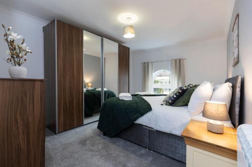 a bedroom with a bed and a large mirror at Albert Park View (free parking!) in Middlesbrough