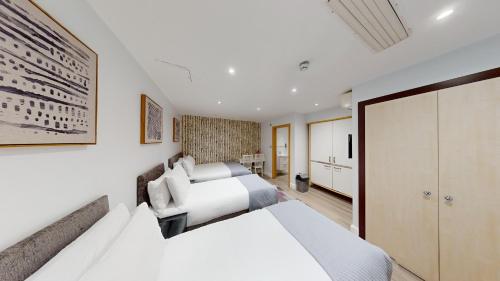 a bedroom with a king sized bed and a closet at MSK Hotel 82 in London