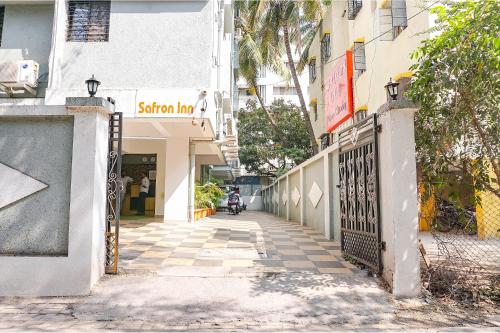 a street with a gate in front of a building at FabHotel Saffron Inn I - Nr Darshan Museum in Pune