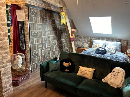 a living room with a couch and a bed at Le Terrier du sorcier in Floyon