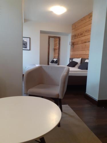a living room with a couch and a bed at Walkowy Dwor in Zakopane
