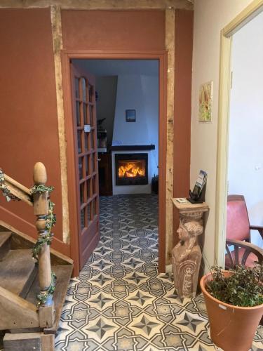 a hallway with a fireplace in a house at Maison d'Hôtes & Savonnerie de Bonnefon in Saint-Chély-dʼAubrac