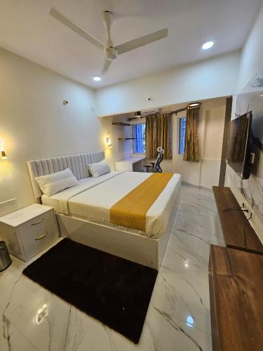 a bedroom with a large bed with a ceiling at SS LUMINA GUEST HOUSE in Bangalore