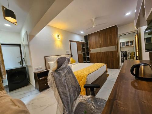 a hotel room with a bed and a table at SS LUMINA GUEST HOUSE in Bangalore