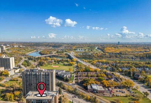 an aerial view of a city with a red arrow on a building at Prime Location Near Jasper Ave with Downtown Views, Netflix, Gym, Sauna, Sleeps 4 in Edmonton
