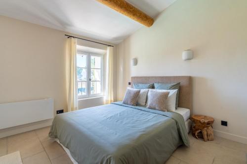 une chambre avec un lit et une fenêtre dans l'établissement La Bastide Des As, à Gordes