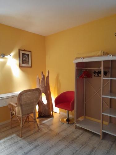 a room with a bed and a chair and a desk at Gîte de Rouviac in Castelnau-Pégayrols