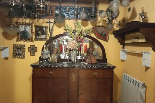 a cabinet with a vase of flowers on top of it at Apartament volcà Rocanegra in Santa Pau
