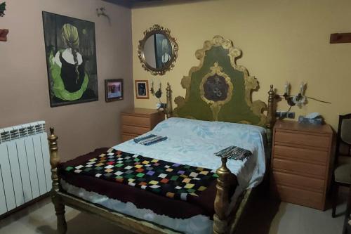 a bedroom with a bed and a mirror at Apartament volcà Rocanegra in Santa Pau