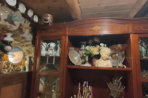 a wooden cabinet filled with lots of different items at Apartament volcà Rocanegra in Santa Pau