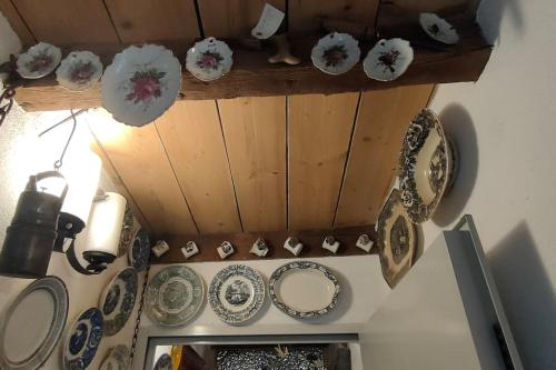 a bunch of plates are hanging on a wall at Apartament volcà Rocanegra in Santa Pau