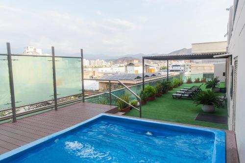 a balcony with a swimming pool on a building at Ribai Hotels Santa Marta in Santa Marta