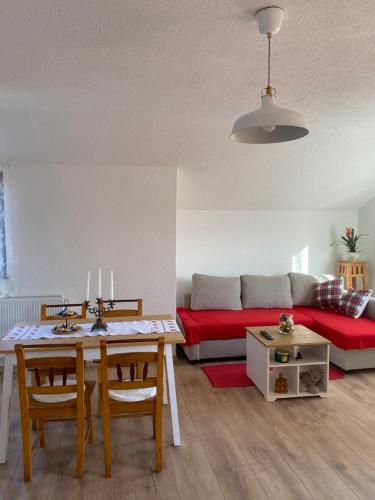 a living room with a table and a couch at Apartman Kremen in Kuterevo