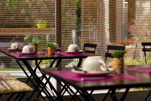 a table with pink napkins and dishes on it at Hotel Chalet De L'isere in Cannes