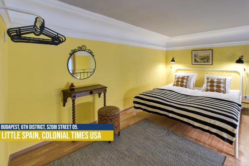 ブダペストにあるLittle Americas Colonial Times Aptsのベッドルーム1室(ベッド1台、壁掛け鏡付)