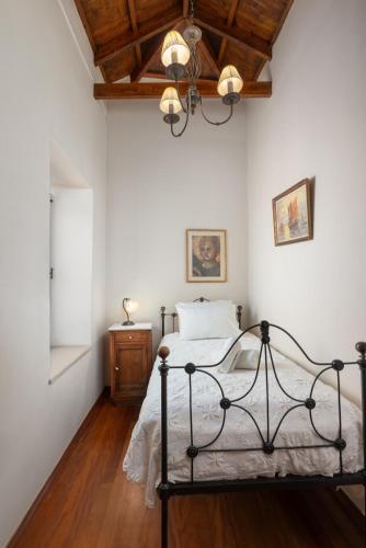 a bedroom with a bed and a wooden ceiling at Kalimera Archanes Village in Archanes