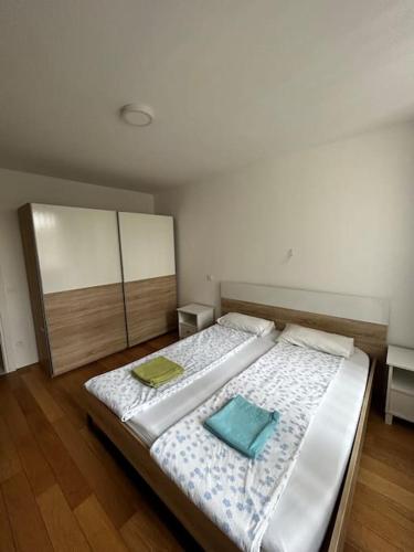 a bedroom with a bed with two pillows on it at Renewed 2 Bedroom Apartment with Parking in Ljubljana