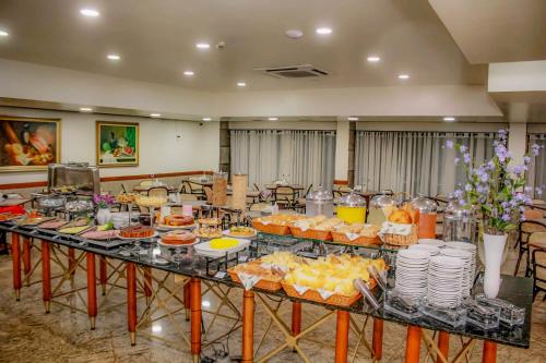 a buffet of food on a table in a room at Hotel Dan Inn Planalto São Paulo in Sao Paulo