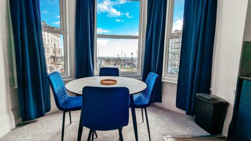 a table and chairs in a room with a window at Eden Apartments in Bridlington
