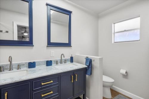 a bathroom with two sinks and a toilet at Shoreline Serenity 3bd Dog Friendly Bckyrd in Satellite Beach