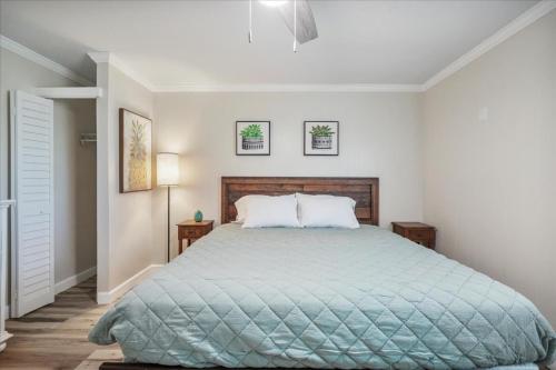 a bedroom with a bed with a blue comforter at Shoreline Serenity 3bd Dog Friendly Bckyrd in Satellite Beach