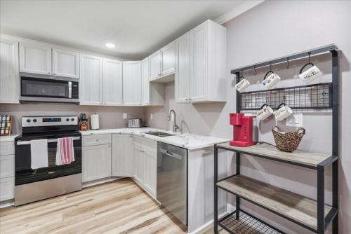 a kitchen with white cabinets and a counter top at Shoreline Serenity 3bd Dog Friendly Bckyrd in Satellite Beach