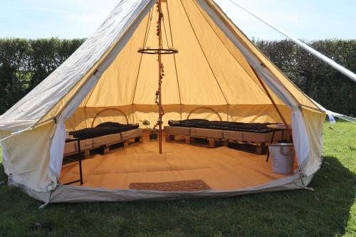 a tent with two beds in it in the grass at Rescorla Retreats - Blossom in St Austell