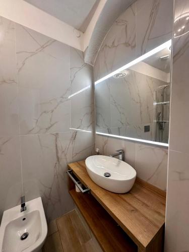 a bathroom with a sink and a mirror at Villa La Caletta in Carloforte