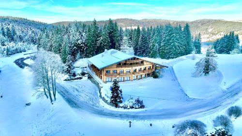 - une vue aérienne sur une maison dans la neige dans l'établissement Hôtel Chalet Frère Joseph, à Ventron