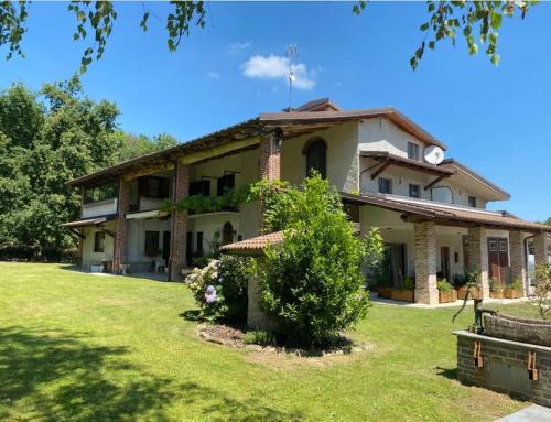 a large house with a grass yard in front of it at Villa Giulia - Argentera in Peveragno