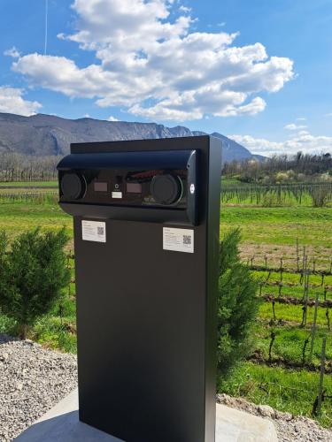 a black machine sitting in the middle of a field at Posestvo Rouna - winery and apartments in Vipava