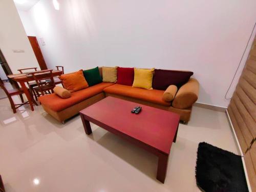 a living room with a couch and a coffee table at A two bedroom luxury apartment at Canterbury Golf Resort in Kahatuduwa
