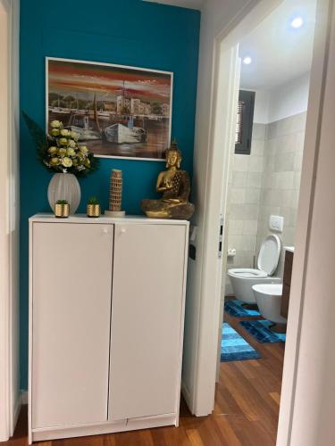 a bathroom with a white cabinet and a toilet at B&B Resilienza in Lecco