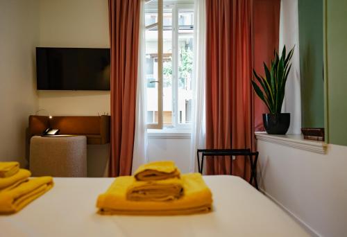 a hotel room with a table with yellow towels on it at Bugan-Villa in Athens