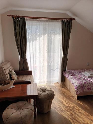 a living room with a bed and a window at Casa Matei in Turda